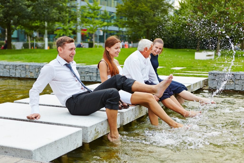 Business colleagues happily splashing water.
