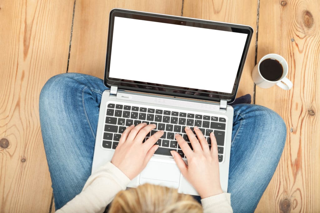 Woman writing follow-up email.