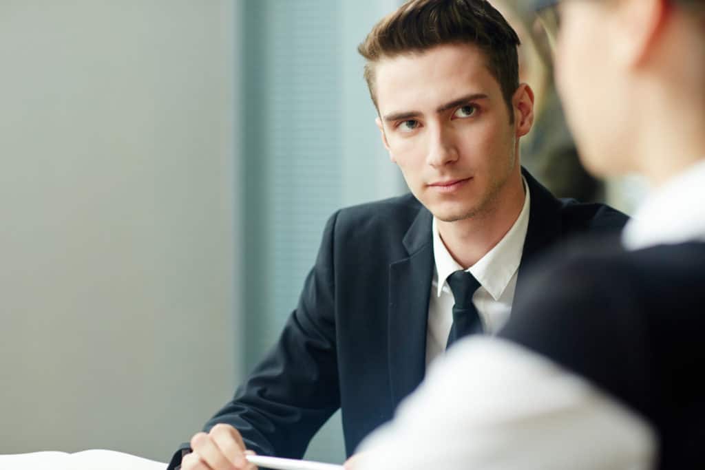 Man thinking as he talks to a candidate who received a counter offer.