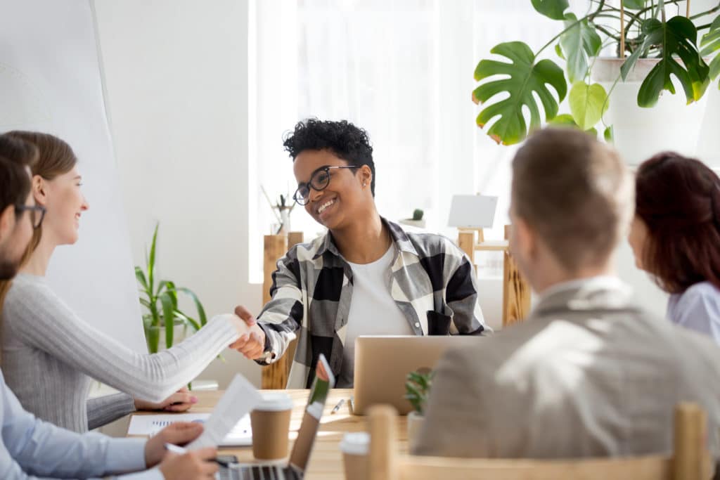 Young woman successfully negotiating with leadership.