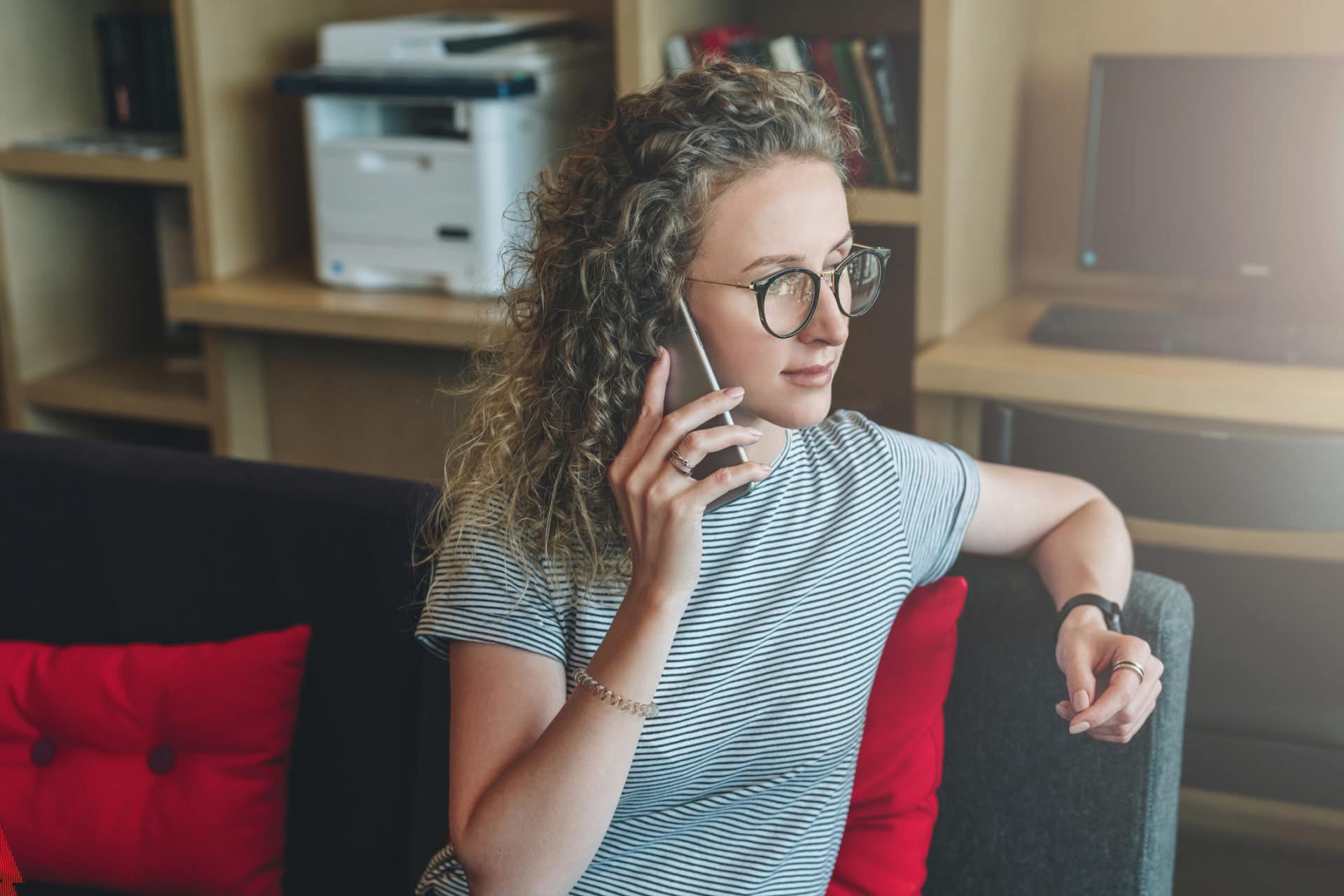 Woman on the phone performing candidate reference checks.
