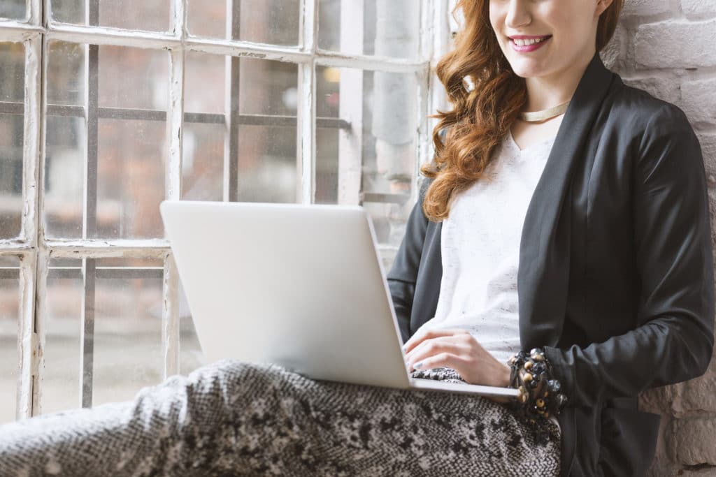 Woman writing a thank you note email on her laptop