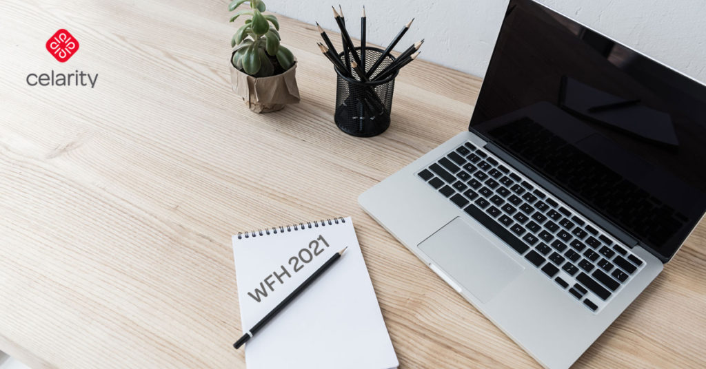 notepad that reads "remote workforce 2021" by computer on a desk